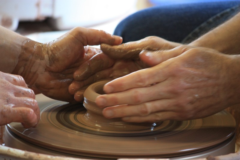 Throwing pottery on the wheel